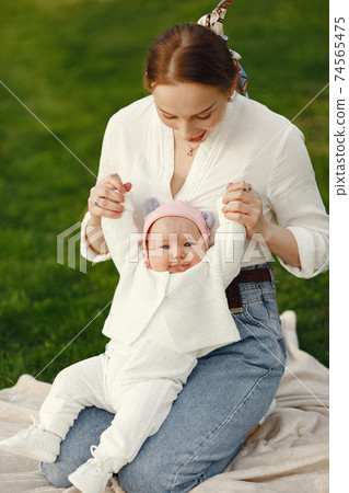 Family spend time in a summer garden 74565475