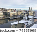Snowscape from Lindenhof hill, Grossmünster cathedral in the old town of Zurich, Switzerland 74565969