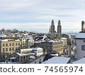 Snowscape from Lindenhof hill, Grossmünster cathedral in the old town of Zurich, Switzerland 74565974