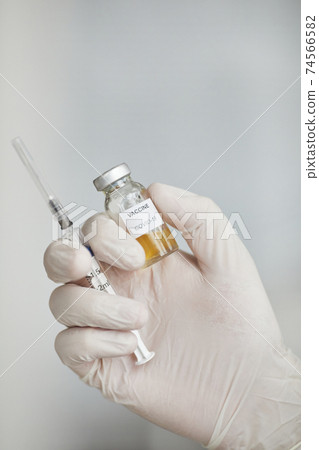 Doctor Holding Covid Vaccine Close Up Doctor Holding Covid Vaccine Close Up 74566582