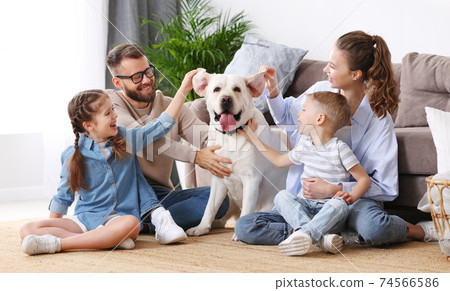 Positive family with kids and dog spending time together at home Positive family with kids and dog spending time together at home 74566586