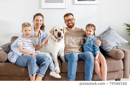 Positive family with kids and dog spending time together at home Positive family with kids and dog spending time together at home 74566588