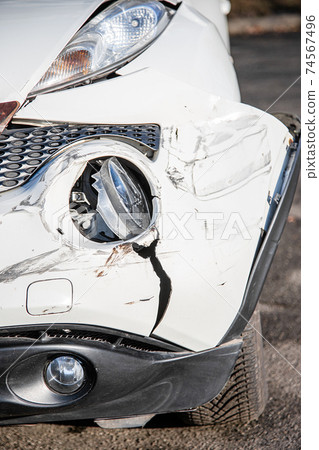 Car accident or accident. The front wing and the right headlight are broken, damage and scratches on the bumper. Broken car parts or close-up. 74567496