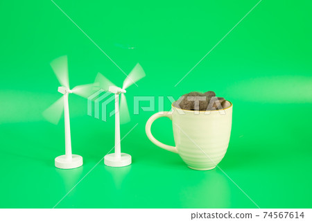 Cute baby brown rabbit in white coffee cup and two wooden white windmill with rotation 74567614