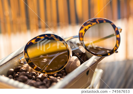 Cat eye sunglasses special model for ladies stay on table in a summer day. Selective focus  74567653