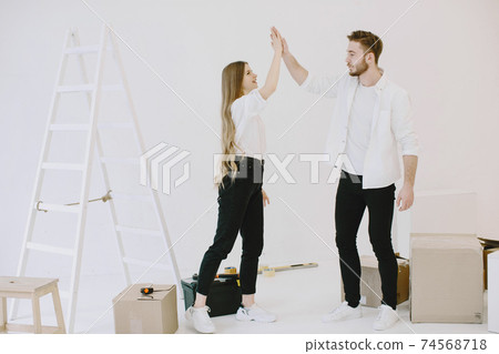Couple moving and using a boxes Couple moving and using a boxes 74568718