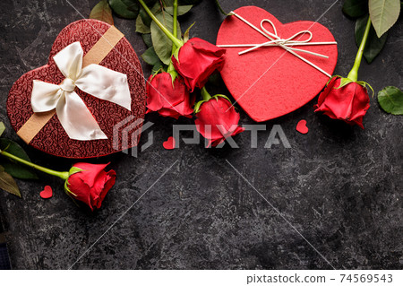 Celebration concept for Saint Valentines day or birthday with hearth shaped gift box and bouquets of red rose Celebration concept for Saint Valentines day or birthday with hearth shaped gift box and bouquets of red rose 74569543