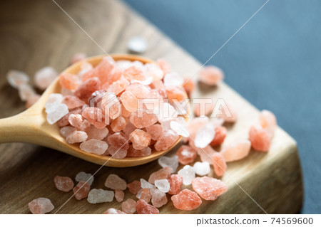Pink Himalayan salt in wooden spoon. 74569600