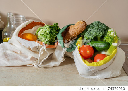 Close up of eco friendly cotton bags with food products Close up of eco friendly cotton bags with food products 74570010