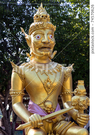 Demon King sits on his golden throne, with a pile of skulls Demon King sits on his golden throne, with a pile of skulls 74570626