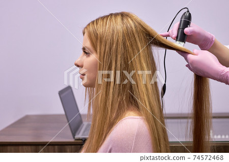 hair diagnostics to female client by professional cosmetologist hair diagnostics to female client by professional cosmetologist 74572468