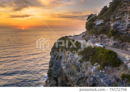 Winding road along rocky coast 74572706