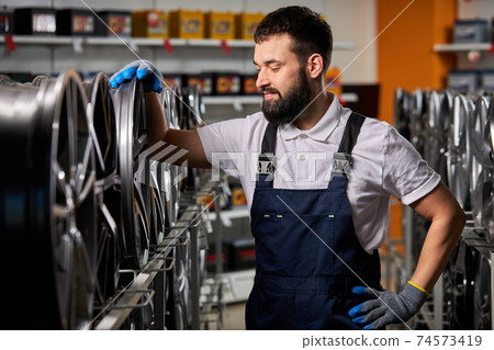 handsome caucasian adult auto mechanic man in uniform have rest 74573419