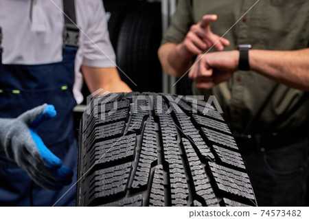 close-up photo of car tire, focus on black tire close-up photo of car tire, focus on black tire 74573482