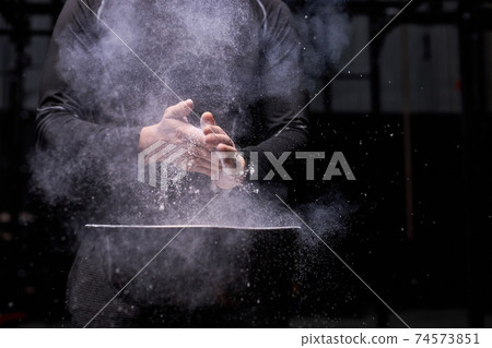 unrecognizable sportsman using talc powder before workout at gym unrecognizable sportsman using talc powder before workout at gym 74573851