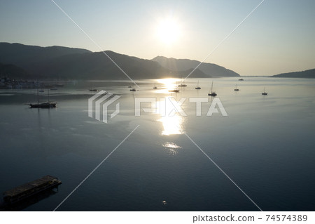 Beautiful view of sea bay with yachts in the morning. Beautiful view of sea bay with yachts in the morning. 74574389