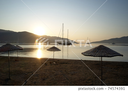 The harbor in the morning with mountains in the background. 74574391