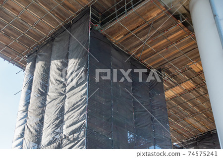 A photo of the bridge girder under repair. Image of construction site. A photo of the bridge girder under repair. Image of construction site. 74575241