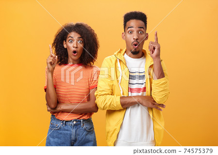 The both got perfect idea at same time. Amazed and excited creative charismatic african american man and woman raising index fingers in eureka gesture opening mouth while adding suggestions The both got perfect idea at same time. Amazed and excited creative charismatic african american man and woman raising index fingers in eureka gesture opening mouth while adding suggestions 74575379