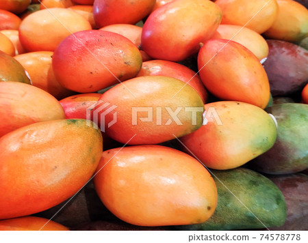 Table with mango fruits in fresh food market. Table with mango fruits in fresh food market. 74578778