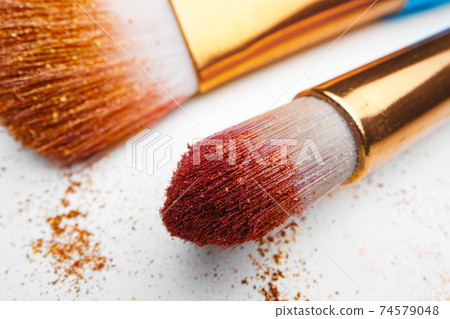 Make-up brush with powder on white background Make-up brush with powder on white background 74579048