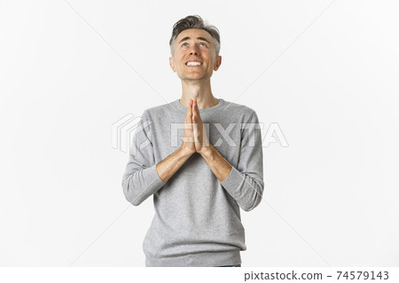 Image of nervous middle-aged man begging God, looking up and pleading for something, supplicating over white background 74579143