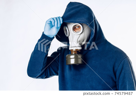 Portrait of a man in a gas mask. Panic during quarantine. Coronavirus pandemia Portrait of a man in a gas mask. Panic during quarantine. Coronavirus pandemia 74579487