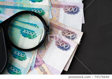 Magnifying Glass on the Russian Currency Rubles Magnifying Glass on the Russian Currency Rubles 74579840