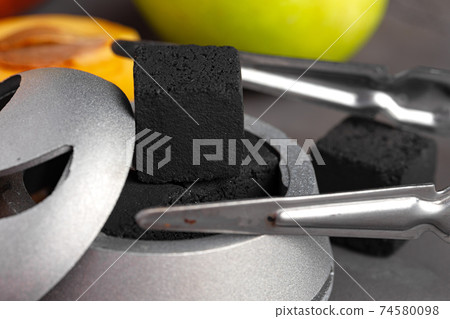 Shisha bowl with coal and .forceps close up 74580098