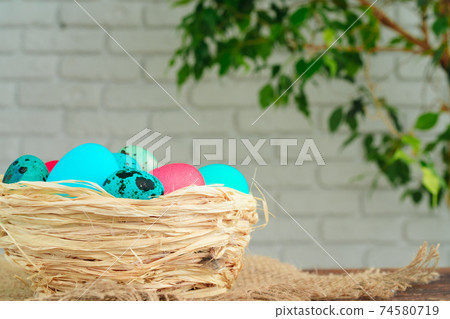 Easter decorative nest with colored eggs close up Easter decorative nest with colored eggs close up 74580719