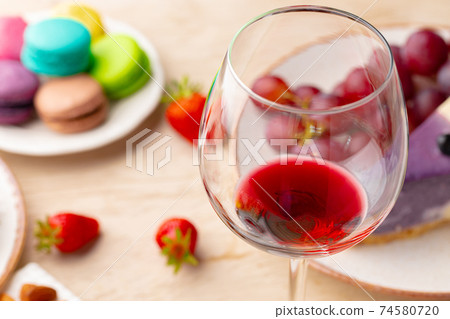 Glass of red wine with appetizer on table close up Glass of red wine with appetizer on table close up 74580720