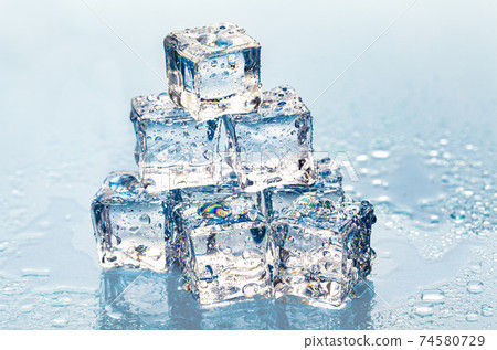 Square melting ice cubes on wet table Square melting ice cubes on wet table 74580729