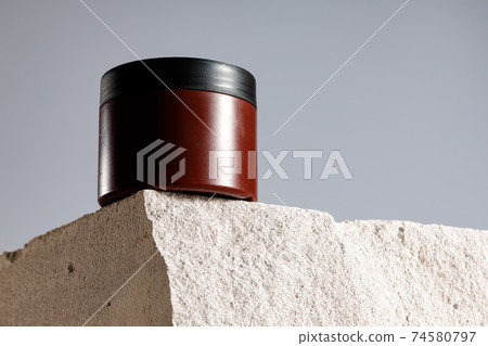 Skincare cosmetic jar on gray cinder block Skincare cosmetic jar on gray cinder block 74580797