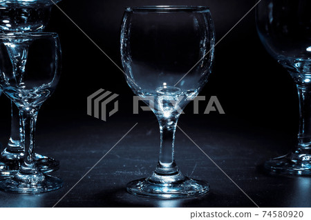 Empty glasses for drinks on dark background 74580920