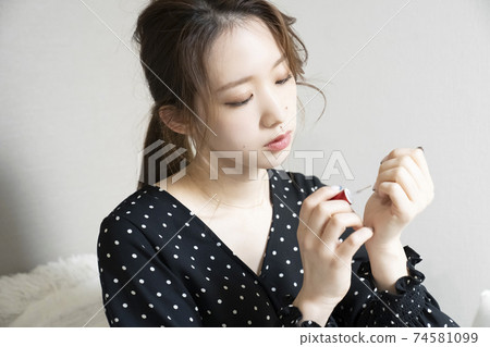 Women painting nails 74581099