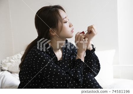 Women painting nails 74581196