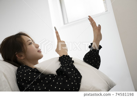 A woman taking nails with her smartphone 74581198