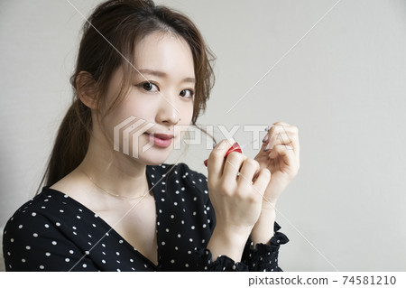 Women painting nails Women painting nails 74581210