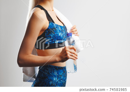 Cropped shot of a fitness woman posing with a towel Cropped shot of a fitness woman posing with a towel 74581985