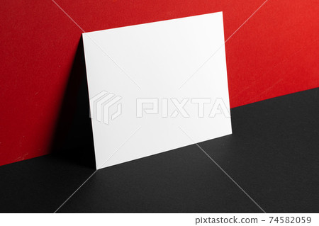 Blank white business cards on red and black paper background Blank white business cards on red and black paper background 74582059