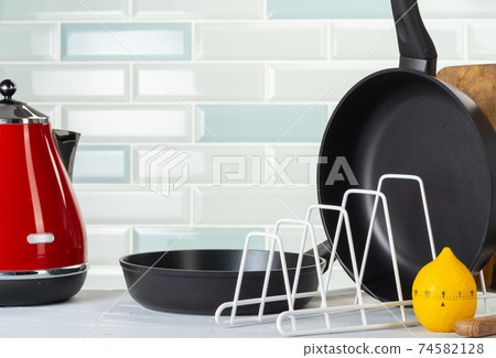 Clean and dry cooking pans on a kitchen counter Clean and dry cooking pans on a kitchen counter 74582128