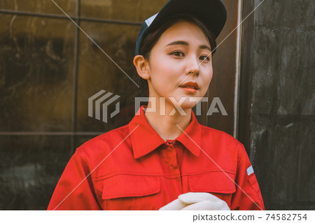 Young woman in red jumpsuit 74582754