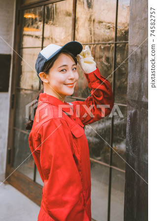 Young woman in red jumpsuit 74582757