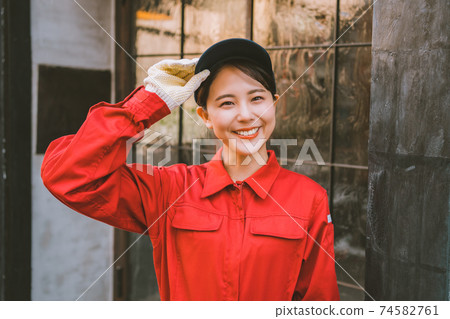Young woman in red jumpsuit 74582761