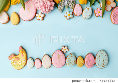 Sweets, pastry, gingerbread cookies for Easter table. Easter eggs and Easter chicken hen on blue background top view copy space, spring seasonal holiday banner for your sute, flyer, coupon 74584138