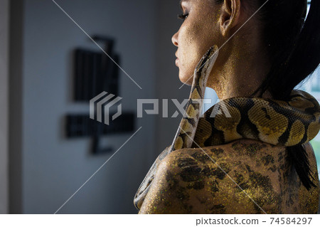 Sensual woman with snake on neck Sensual woman with snake on neck 74584297