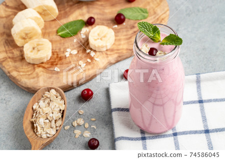 Homemade yogurt smoothie with banana, cranberry and oatmeal Homemade yogurt smoothie with banana, cranberry and oatmeal 74586045