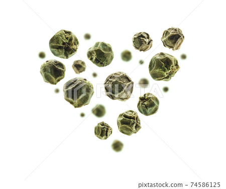 Green peppercorns in the shape of a heart on a white background Green peppercorns in the shape of a heart on a white background 74586125