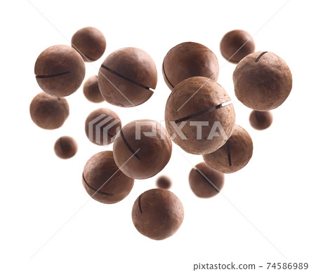 Unpeeled macadamia nuts in the shape of a heart on a white background Unpeeled macadamia nuts in the shape of a heart on a white background 74586989