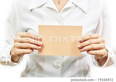 Business woman holding empty orange card on white background Business woman holding empty orange card on white background 74588972